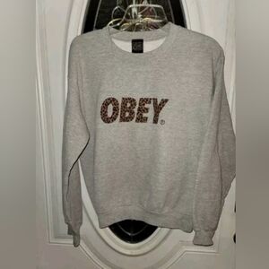 OBEY Women’s Pullover Sweatshirt Size Small Cheetah Print Spell Out